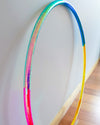 LED Rainbow Hula Hoop with rainbow design, partially collapsible for easy storage and travel