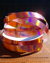 Pink holographic hula hoop tape with a light reflecting finish for decorating hula hoops